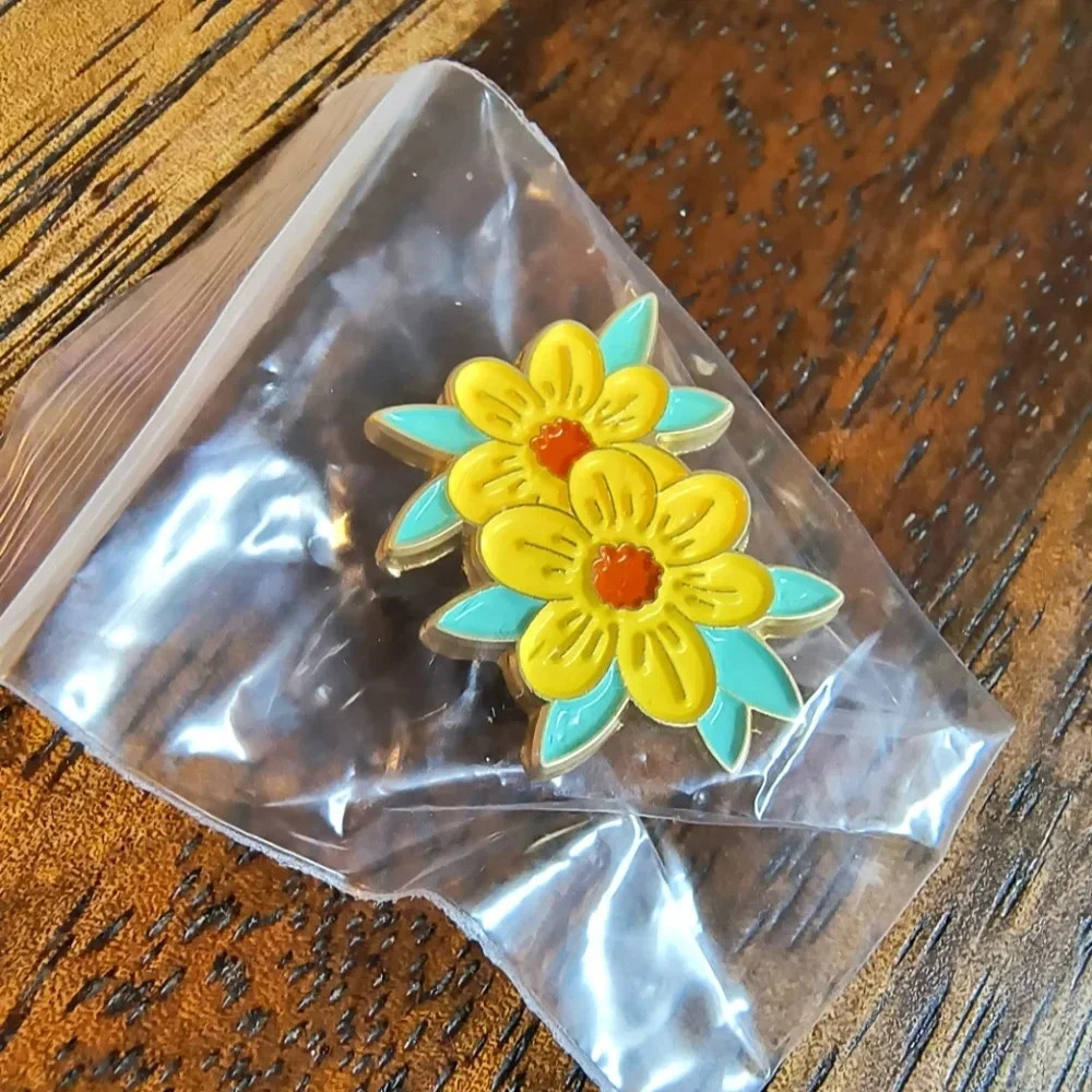 Yellow orange flowers green leaves enamel pin backpack hat clothes bag cap